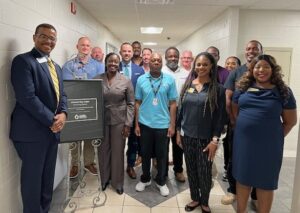 Group at naming plaque